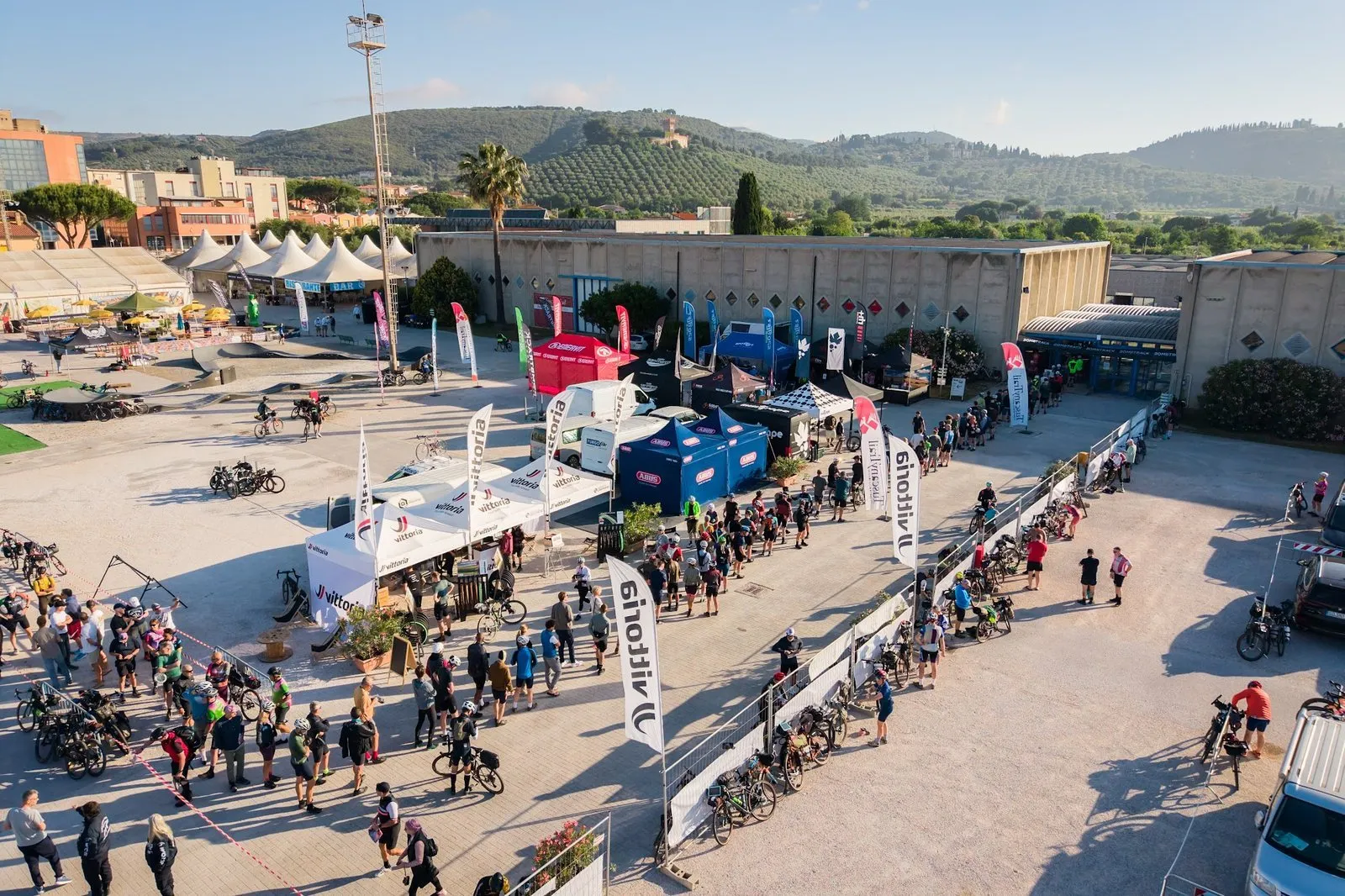 The Tuscany Trail village in Venturina Terme seen from a drone, with the stands and riders queuing for the start
